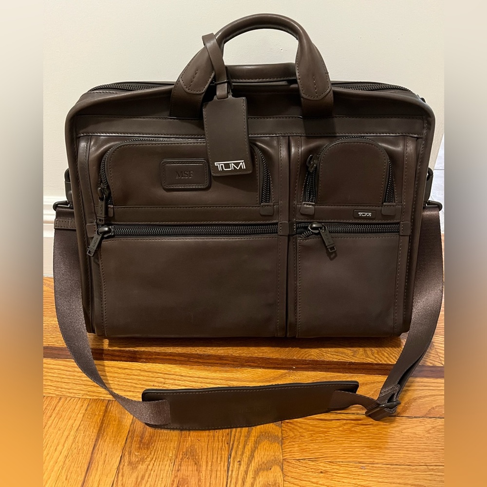 Tumi brown leather briefcase with laptop sleeve. Never used. Shoulder strap.
